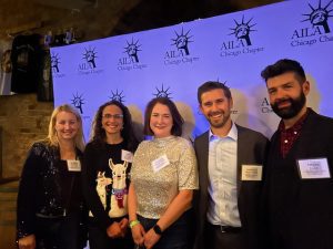 Five people standing in front of a backdrop at an AILA Chicago Chapter event.